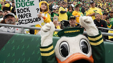 Eight-year-old Parker, left, challenges the Duck to a game of Rock, Paper, Scissors during the game against Indiana at Autzen Stadium October 11, 2025.