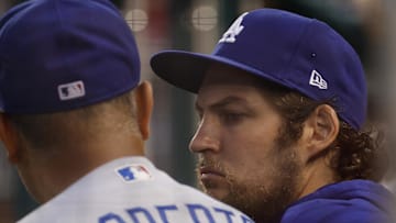 Jul 1, 2021; Washington, District of Columbia, USA; Los Angeles Dodgers starting pitcher Trevor Bauer (R) talks with Dodgers manager Dave Roberts (L) in the dugout against the Washington Nationals in the third inning at Nationals Park.