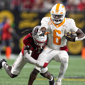 Sep 7, 2024; Charlotte, North Carolina, USA; North Carolina State Wolfpack linebacker Sean Brown (0) tackles Tennessee Volunteers running back Dylan Sampson (6) during the second half at the Dukes Mayo Classic at Bank of America Stadium. Mandatory Credit: Jim Dedmon-Imagn Images