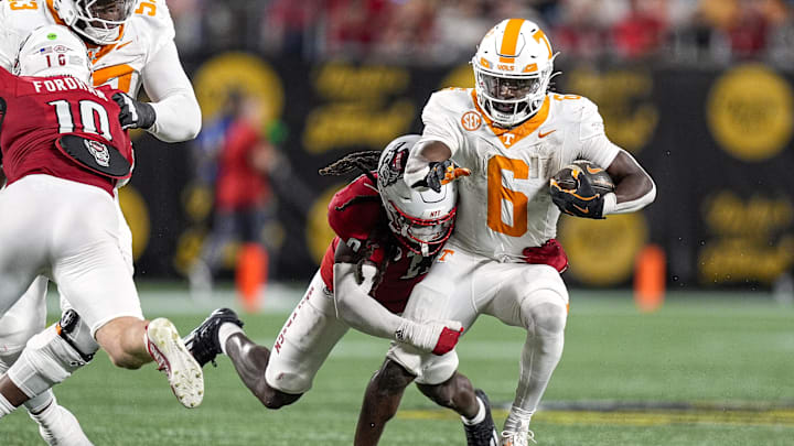 Sep 7, 2024; Charlotte, North Carolina, USA; North Carolina State Wolfpack linebacker Sean Brown (0) tackles Tennessee Volunteers running back Dylan Sampson (6) during the second half at the Dukes Mayo Classic at Bank of America Stadium. Mandatory Credit: Jim Dedmon-Imagn Images