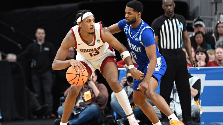 Mar 21, 2024; Omaha, NE, USA; Washington State Cougars forward Isaac Jones (13) controls the ball against Drake Bulldogs guard Kyron Gibson (0) in the second half in the first round of the 2024 NCAA Tournament at CHI Health Center Omaha. Mandatory Credit: Steven Branscombe-USA TODAY Sports
