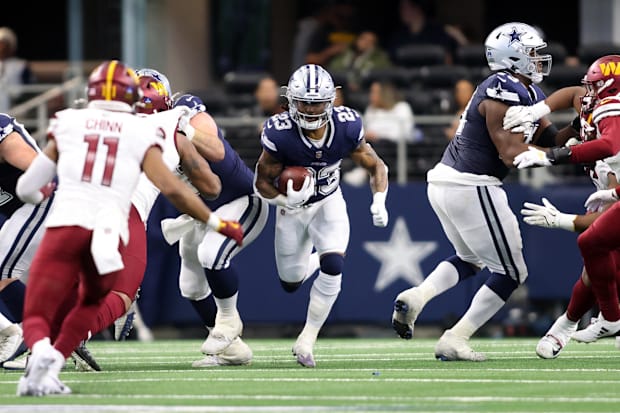 Dallas Cowboys running back Rico Dowdle (23) runs the ball against the Washington Commanders during the second quarter