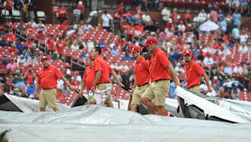 Sep 4, 2022; St. Louis, Missouri, USA; Grounds crew putting the tarp on the field during a rain delay prior to a game between the St. Louis Cardinals and the Chicago Cubs at Busch Stadium. Mandatory Credit: Joe Puetz-Imagn Images