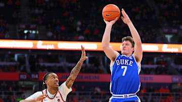 Feb 5, 2025; Syracuse, New York, USA; Duke Blue Devils guard Kon Knueppel (7) shoots against Syracuse Orange guard Lucas Taylor (3) during the first half at the JMA Wireless Dome. Mandatory Credit: Rich Barnes-Imagn Images