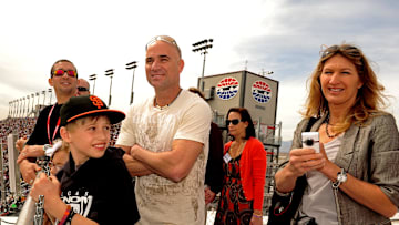 Mar. 6, 2011; Las Vegas, NV, USA; Former tennis players Andre Agassi (center) with wife Steffi Graf (right) and son Jaden Agassi in attendance during the Kobalt Tools 400 at Las Vegas Motor Speedway. 