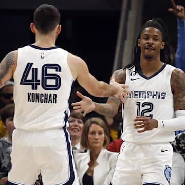 Memphis Grizzlies guard Ja Morant (12) reacts with guard John Konchar (46) after a basket against the New Orleans Pelicans during the first quarter  at FedExForum. 