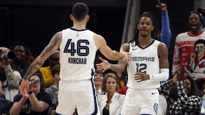 Memphis Grizzlies guard Ja Morant (12) reacts with guard John Konchar (46) after a basket against the New Orleans Pelicans during the first quarter  at FedExForum. 