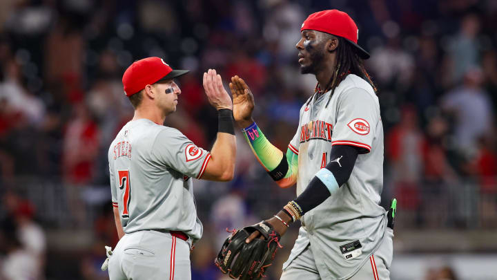 Jul 22, 2024; Atlanta, Georgia, USA; Cincinnati Reds first baseman Spencer Steer (7) and shortstop Elly De La Cruz (44) celebrate after a victory over the Atlanta Braves at Truist Park. Mandatory Credit: Brett Davis-USA TODAY Sports