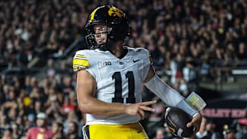 Sep 19, 2025; Piscataway, New Jersey, USA; Iowa Hawkeyes quarterback Mark Gronowski (11) celebrates after scoring a rushing touchdown during the first half against the Rutgers Scarlet Knights at SHI Stadium. Mandatory Credit: Vincent Carchietta-Imagn Images