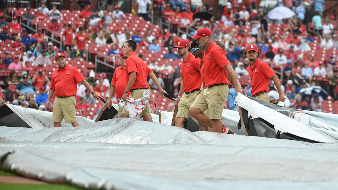 Sep 4, 2022; St. Louis, Missouri, USA; Grounds crew putting the tarp on the field during a rain delay prior to a game between the St. Louis Cardinals and the Chicago Cubs at Busch Stadium. Mandatory Credit: Joe Puetz-Imagn Images