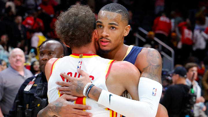 Trae Young #11 of the Atlanta Hawks hugs Dejounte Murray #5 of the New Orleans Pelicans.