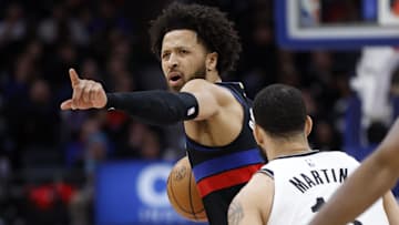 Mar 1, 2025; Detroit, Michigan, USA;  Detroit Pistons guard Cade Cunningham (2) is defended by Brooklyn Nets guard Tyrese Martin (13) in the second half at Little Caesars Arena. Mandatory Credit: Rick Osentoski-Imagn Images