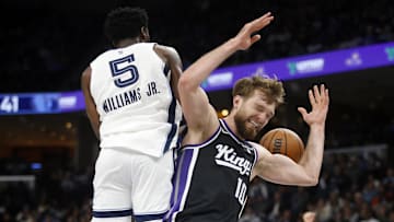 Dec 31, 2023; Memphis, Tennessee, USA; Memphis Grizzlies guard Vince Williams Jr. (5) and Sacramento Kings forward Domantas Sabonis (10) battle for a rebound during the first half at FedExForum. Mandatory Credit: Petre Thomas-Imagn Images
