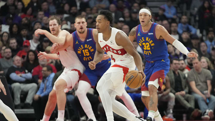 Toronto Raptors forward Scottie Barnes (4) looks to move the ball as Denver Nuggets center Nikola Jokic (15) and forward Aaron Gordon (32) defend during the first half at Scotiabank Arena. Mandatory Credit: John E. Sokolowski-Imagn Images Toronto Raptors forward Scottie Barnes (4) looks to move the ball as Denver Nuggets center Nikola Jokic (15) and forward Aaron Gordon (32) defend during the first half at Scotiabank Arena. Mandatory Credit: John E. Sokolowski-Imagn Images