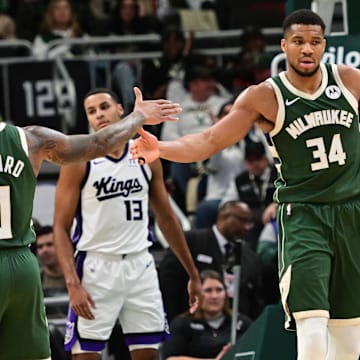 Jan 14, 2025; Milwaukee, Wisconsin, USA; Milwaukee Bucks forward Giannis Antetokounmpo (34) reacts with guard Damian Lillard (0) after scoring a basket in the second quarter against the Sacramento Kings at Fiserv Forum. Mandatory Credit: Benny Sieu-Imagn Images