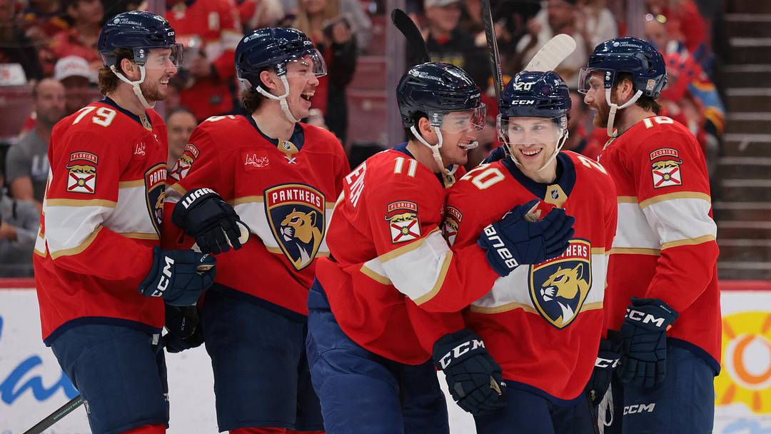 Apr 15, 2026; Sunrise, Florida, USA; Florida Panthers defenseman Mike Benning (20) celebrates with right wing MacKie Samoskevich (11) after scoring against the Detroit Red Wings during the second period at Amerant Bank Arena. Mandatory Credit: Sam Navarro-Imagn Images