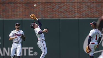 May 15, 2025; Cumberland, Georgia, USA; Atlanta Braves shortstop Nick Allen (2) catches a fly ball between outfielder outfielder Eli White (36) and second base Ozzie Albies (1) against the Washington Nationals during the second inning at Truist Park. Mandatory Credit: Dale Zanine-Imagn Images