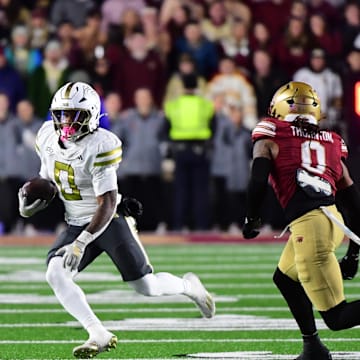 Nov 15, 2025; Chestnut Hill, Massachusetts, USA; Georgia Tech Yellow Jackets running back Malachi Hosley (0) runs the ball while Boston College Eagles defensive back Omar Thornton (0) defends during the second half at Alumni Stadium. Mandatory Credit: Bob DeChiara-Imagn Images