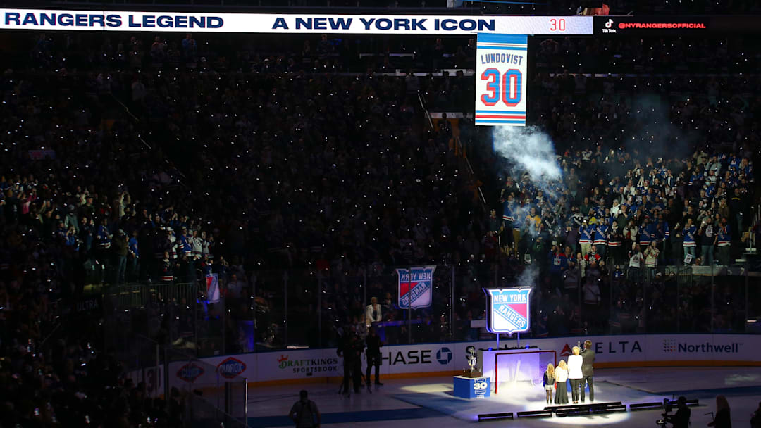 Jan 28, 2022; New York, New York, USA; New York Rangers former goalie Henrik Lundqvist watches with his family as his banner is raised to the ceiling during a ceremony to retire his number before a game against the Minnesota Wild at Madison Square Garden. Mandatory Credit: Brad Penner-Imagn Images