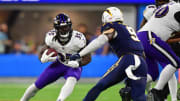 Nov 26, 2023; Inglewood, California, USA; Baltimore Ravens running back Gus Edwards (35) moves the ball against Los Angeles Chargers linebacker Kenneth Murray Jr. (9) during the second half at SoFi Stadium. Mandatory Credit: Gary A. Vasquez-USA TODAY Sports