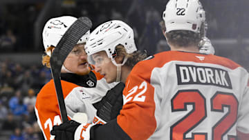 Nov 14, 2025; St. Louis, Missouri, USA; Philadelphia Flyers center Trevor Zegras (46) is congratulated by right wing Owen Tippett (74) and center Christian Dvorak (22) after scoring against the St. Louis Blues during the first period at Enterprise Center.