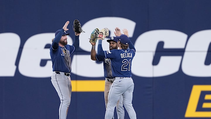 May 12, 2026; Toronto, Ontario, CAN; Tampa Bay Rays right fielder Ryan Vilade (26) and center fielder Cedric Mullins (31) and  right fielder Jonny DeLuca (21) celebrate the win against the Toronto Blue Jays at the end of the tenth  inning at Rogers Centre. Mandatory Credit: Nick Turchiaro-Imagn Images