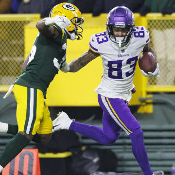 Jan 1, 2023; Green Bay, Wisconsin, USA;  Minnesota Vikings wide receiver Jalen Nailor (83) rushes for a touchdown as Green Bay Packers cornerback Corey Ballentine (35) defends during the fourth quarter at Lambeau Field. Mandatory Credit: Jeff Hanisch-USA TODAY Sports
