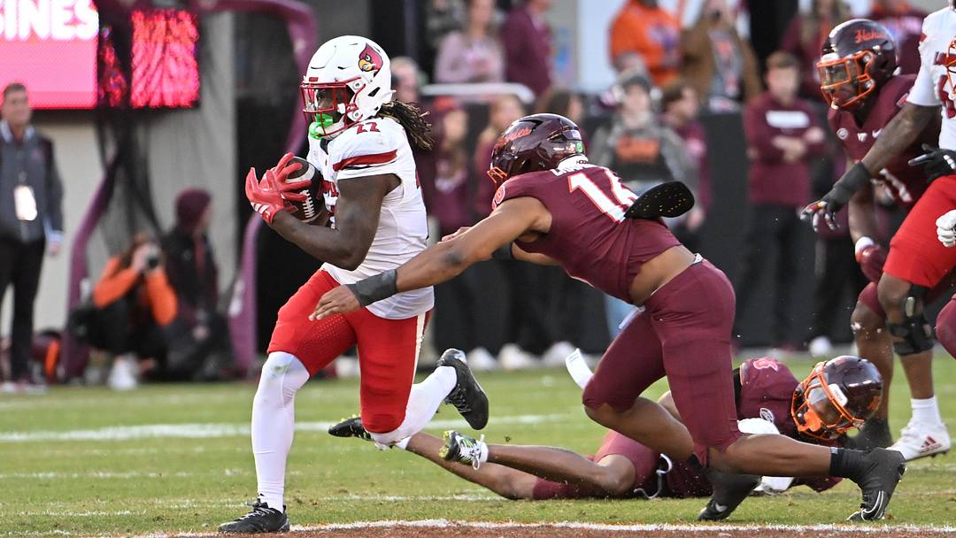 Nov 1, 2025; Blacksburg, Virginia, USA;  Virginia Tech Hokies linebacker Noah Chambers (16) tackles Louisville Cardinals running back Keyjuan Brown (22) during the fourth quarter at Lane Stadium. Mandatory Credit: Brian Bishop-Imagn Images