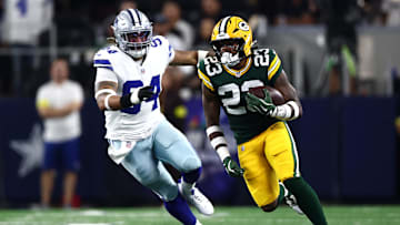 Sep 28, 2025; Arlington, Texas, USA; Green Bay Packers running back Emanuel Wilson (23) runs against Dallas Cowboys defensive end Marshawn Kneeland (94) in the first quarter at AT&T Stadium. Mandatory Credit: Kevin Jairaj-Imagn Images