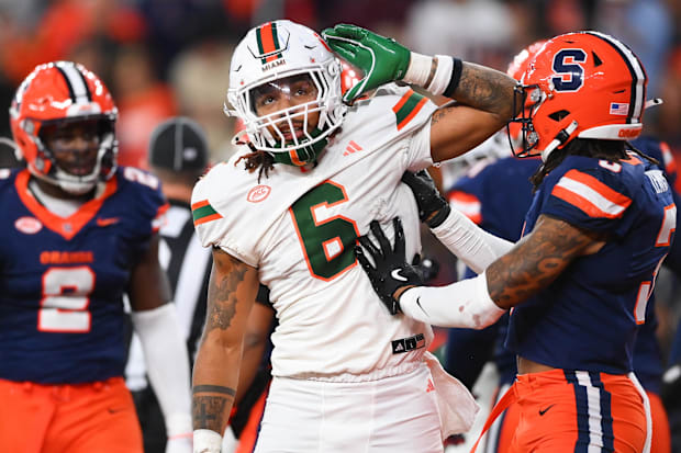 Miami Hurricanes running back Damien Martinez gestures to fans after running for a touchdown against the Syracuse Orange.