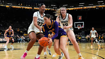 Ashland guard Alysa Lopez (0) races Iowa forward Jada Gyamfi (23) and Iowa center Layla Hays (12) to a loose ball Oct. 30, 2025 during an exhibition game at Carver-Hawkeye Arena in Iowa City, Iowa.