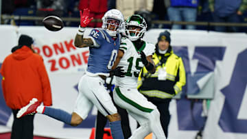 Nov 13, 2025; Foxborough, Massachusetts, USA; New England Patriots Christian Gonzalez cornerback (0) defends against New York Jets wide receiver Adonai Mitchell (15) in the fourth quarter at Gillette Stadium. Mandatory Credit: David Butler II-Imagn Images