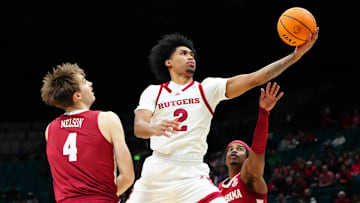 Nov 27, 2024; Las Vegas, Nevada, USA; Rutgers Scarlet Knights guard Dylan Harper (2) shoots between Alabama Crimson Tide forward Grant Nelson (4) and Alabama Crimson Tide forward Jarin Stevenson (15) during the first half at MGM Grand Garden Arena. Mandatory Credit: Stephen R. Sylvanie-Imagn Images