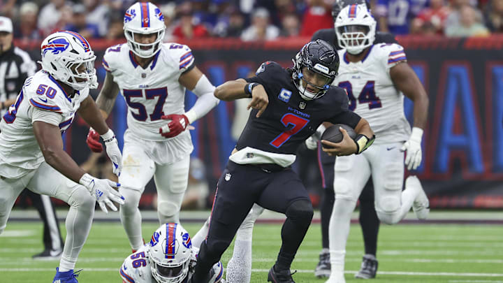 Oct 6, 2024; Houston, Texas, USA; Houston Texans quarterback C.J. Stroud (7) runs with the ball as Buffalo Bills defensive end Javon Solomon (56) attempts to make a tackle during the game at NRG Stadium. Mandatory Credit: Troy Taormina-Imagn Images