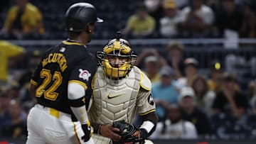 San Diego Padres catcher Luis Campusano (12) tags Pittsburgh Pirates designated hitter Andrew McCutchen (22) out at home plate during the tenth inning at PNC Park. San Diego won 9-8 in ten innings on Aug. 7, 2024.