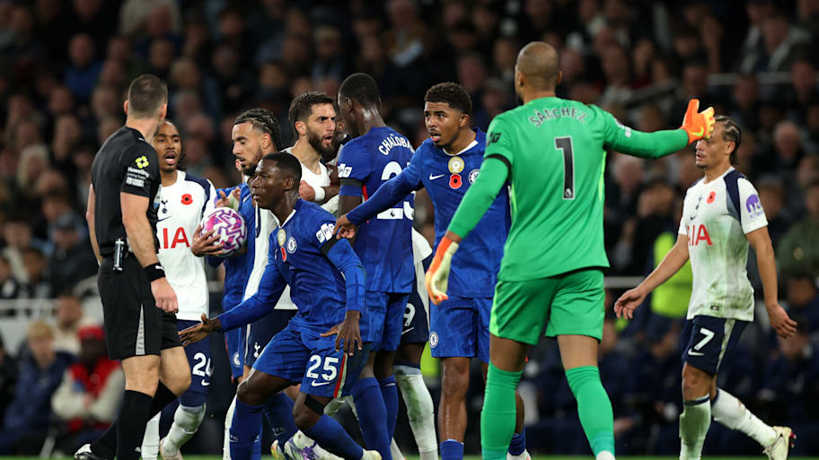 Tottenham and Chelsea players scuffling.