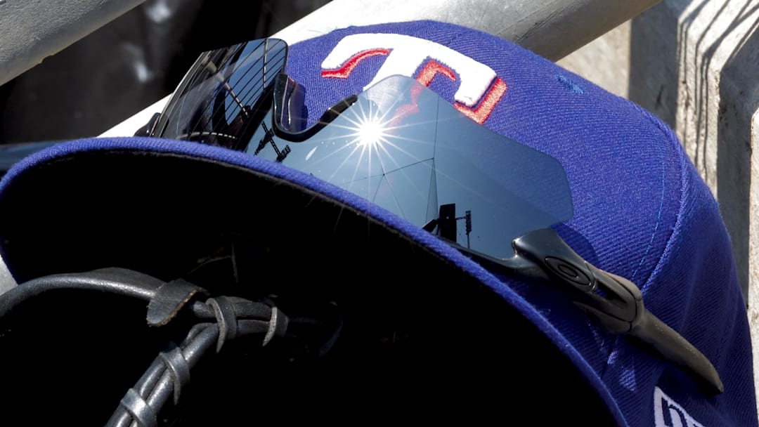 May 29, 2023; Detroit, Michigan, USA;  Texas Rangers cap in glove sits in dugout during the eighth inning against the Detroit Tigers at Comerica Park. 