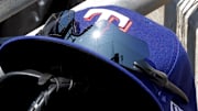 May 29, 2023; Detroit, Michigan, USA;  Texas Rangers cap in glove sits in dugout during the eighth inning against the Detroit Tigers at Comerica Park. Mandatory Credit: Rick Osentoski-Imagn Images