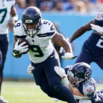 Seattle Seahawks running back Kenneth Walker III (9) is pulled down by Tennessee Titans linebacker Garret Wallow (54) during the second quarter at Nissan Stadium in Nashville, Tenn., Sunday, Dec. 24, 2023.