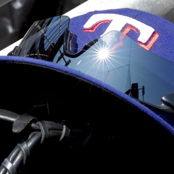 May 29, 2023; Detroit, Michigan, USA;  Texas Rangers cap in glove sits in dugout.