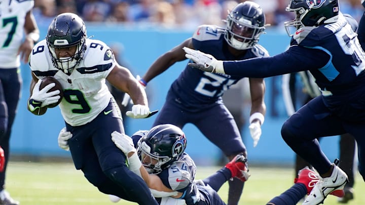 Seattle Seahawks running back Kenneth Walker III (9) is pulled down by Tennessee Titans linebacker Garret Wallow (54) during the second quarter at Nissan Stadium in Nashville, Tenn., Sunday, Dec. 24, 2023.