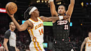 Apr 1, 2025; Atlanta, Georgia, USA; Atlanta Hawks guard Terance Mann (14) passes against Portland Trail Blazers forward Toumani Camara (33) during the first half at State Farm Arena. Mandatory Credit: Dale Zanine-Imagn Images