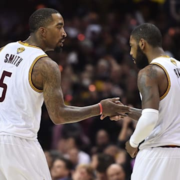 Cleveland Cavaliers guard JR Smith and guard Kyrie Irving greet each other.
