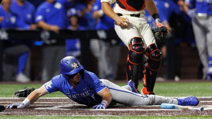Jun 9, 2024; Lexington, KY, USA; Kentucky Wildcats outfielder Nolan McCarthy (19) slides in safe at home on a wild pitch during the seventh inning against the Oregon State Beavers at Kentucky Proud Park. Mandatory Credit: Jordan Prather-USA TODAY Sports