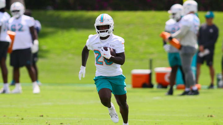 Jun 4, 2024; Miami Gardens, FL, USA; Miami Dolphins running back De'Von Achane (28) runs with the football during a mandatory minicamp at Baptist Health Training Complex.