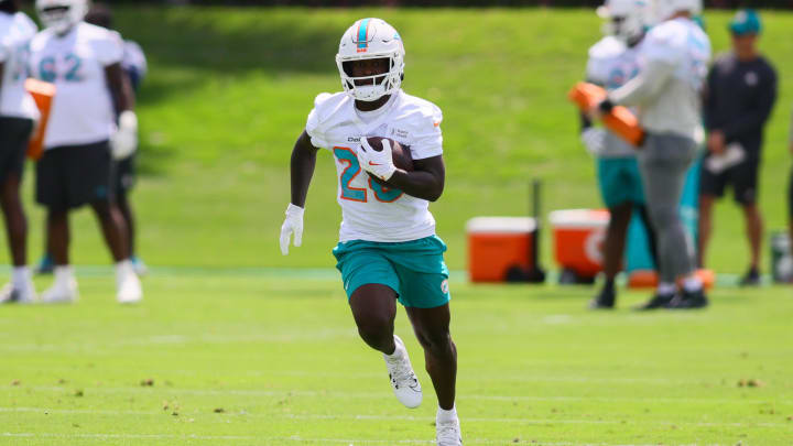 Miami Dolphins running back De'Von Achane runs with the football during mandatory minicamp at Baptist Health Training Complex. 