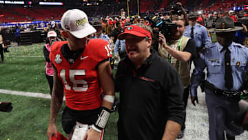 Dec 7, 2024; Atlanta, GA, USA; Georgia Bulldogs quarterback Carson Beck (15) and head coach Kirby Smart  react after defeating the Texas Longhorns in overtime in the 2024 SEC Championship game at Mercedes-Benz Stadium. Mandatory Credit: Brett Davis-Imagn Images