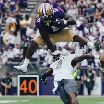 Giles Jackson leaps over an Eastern Michigan defender. 