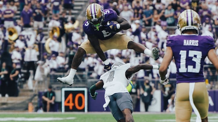 Giles Jackson leaps over an Eastern Michigan defender. 