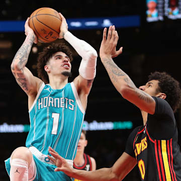Mar 12, 2025; Atlanta, Georgia, USA; Charlotte Hornets guard LaMelo Ball (1) shoots against Atlanta Hawks forward Dominick Barlow (0) during the second half at State Farm Arena. Mandatory Credit: Mady Mertens-Imagn Images